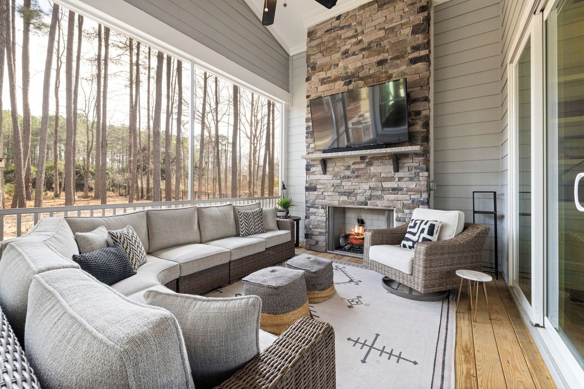 Covered patio with a floor-to-ceiling natural stone veneer fireplace